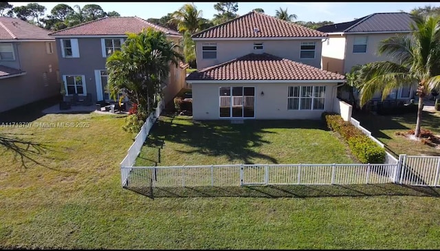 rear view of house featuring a yard