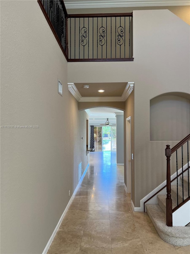 hall with crown molding and an inviting chandelier