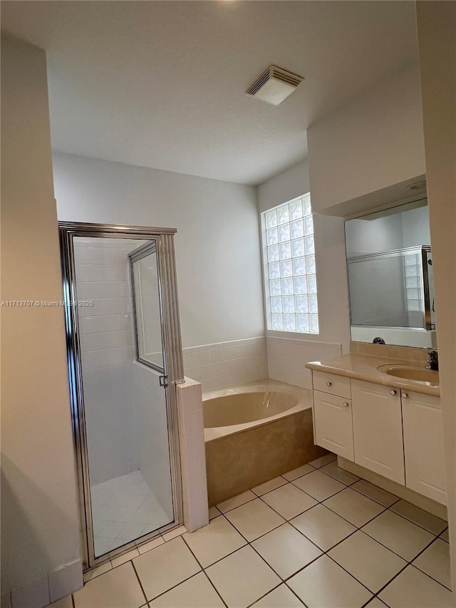 bathroom with tile patterned floors, vanity, and separate shower and tub