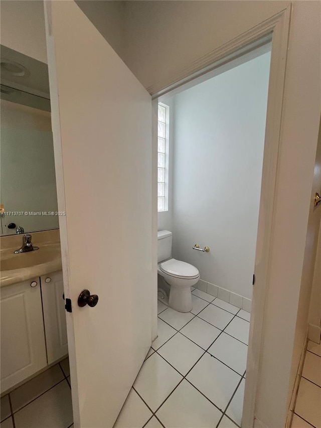 bathroom with tile patterned floors, toilet, and sink