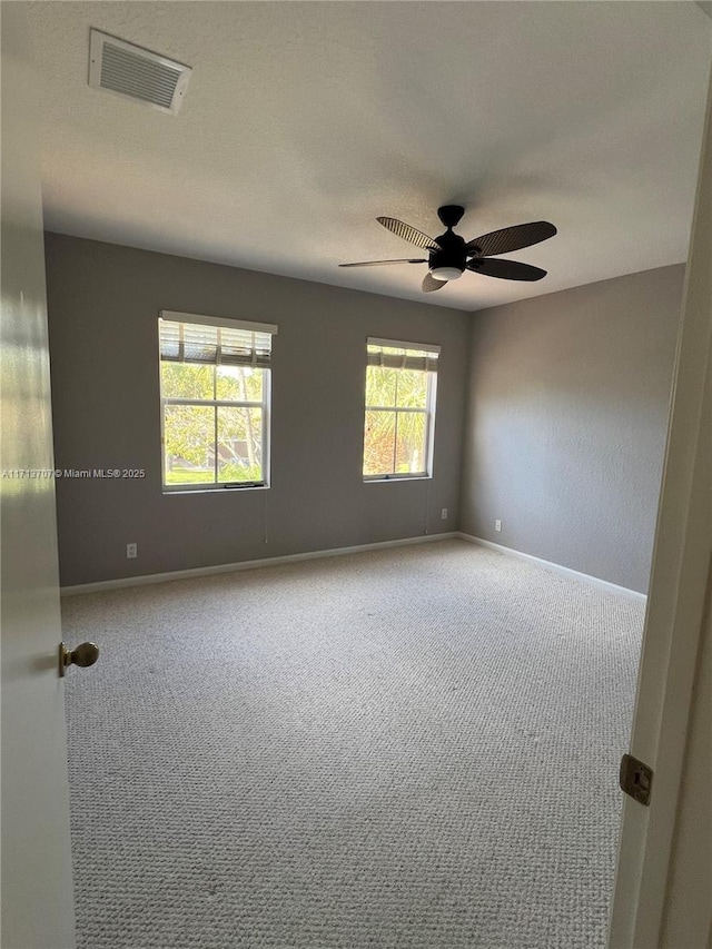 carpeted empty room with ceiling fan