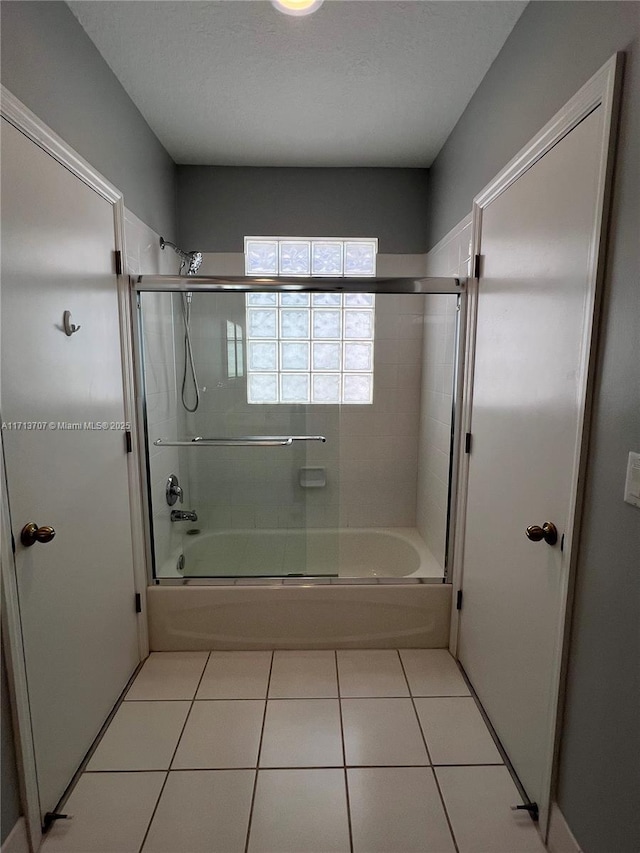 bathroom with tile patterned floors and enclosed tub / shower combo