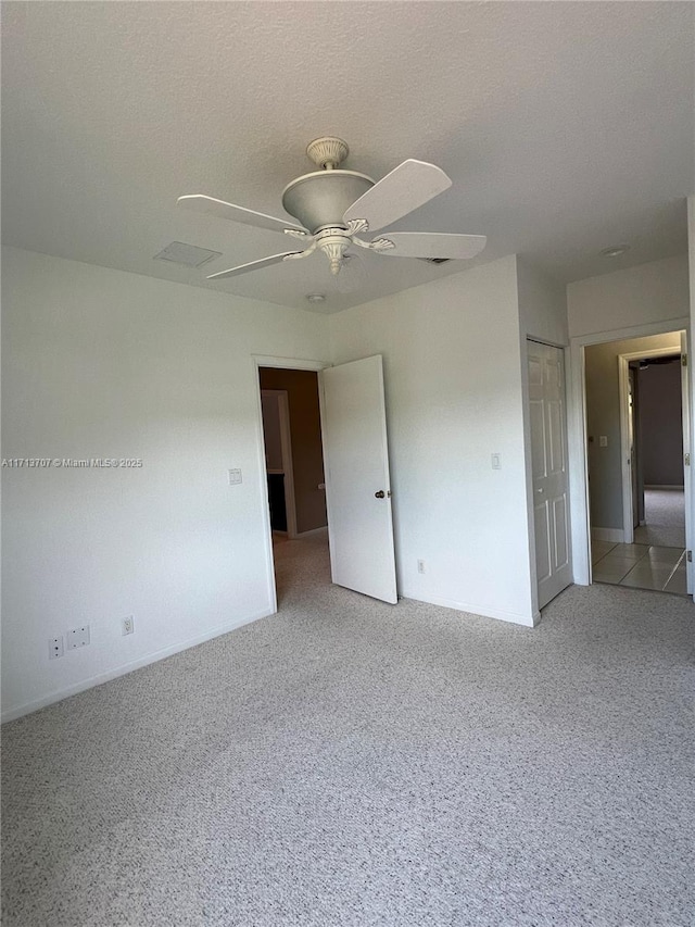 empty room featuring carpet and ceiling fan