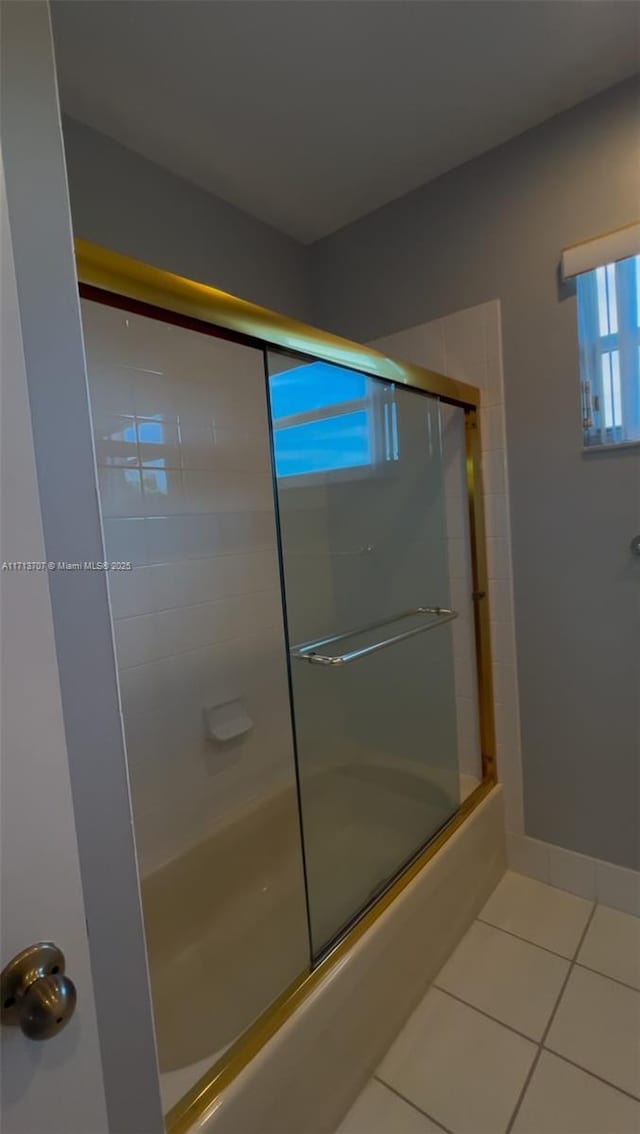 bathroom featuring tile patterned floors and enclosed tub / shower combo