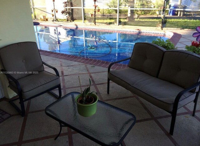 pool with a lanai, a patio, and an outdoor living space