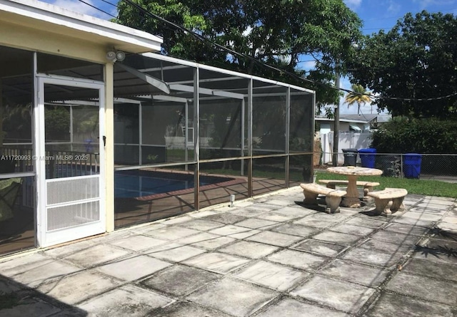 view of patio / terrace featuring a lanai, a fenced in pool, and fence