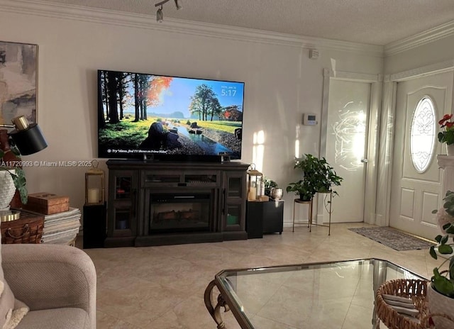 living room featuring tile patterned floors, ornamental molding, and a textured ceiling