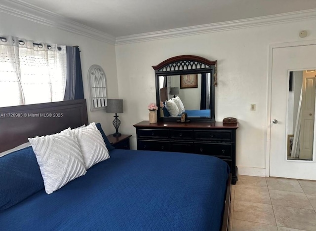bedroom with ornamental molding, baseboards, and light tile patterned floors