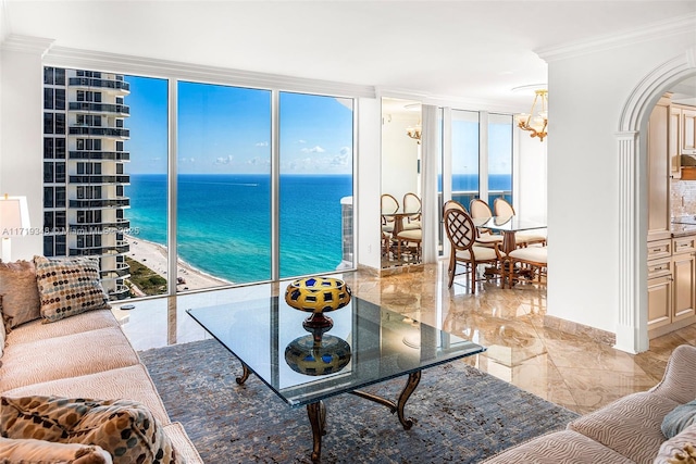 living room with floor to ceiling windows, a water view, and ornamental molding