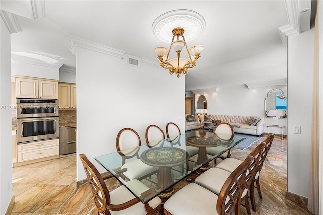 dining space with a chandelier and crown molding