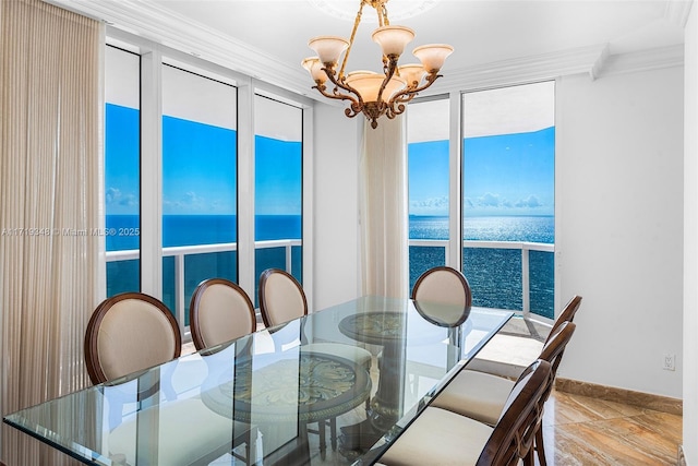 dining space featuring a water view, crown molding, and a notable chandelier