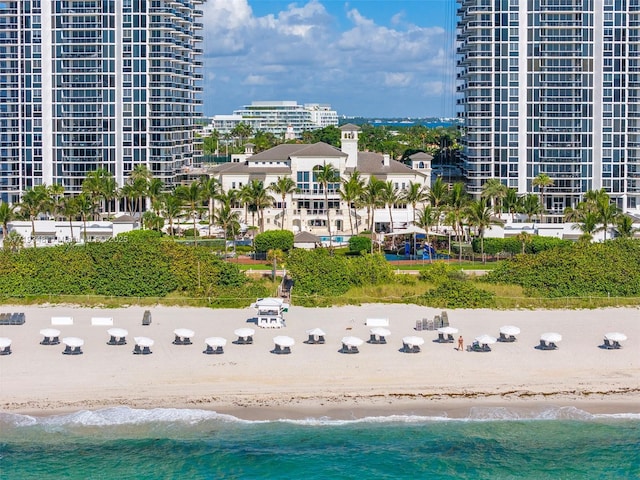 birds eye view of property featuring a view of the beach and a water view