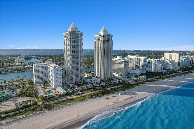 property's view of city with a water view and a beach view