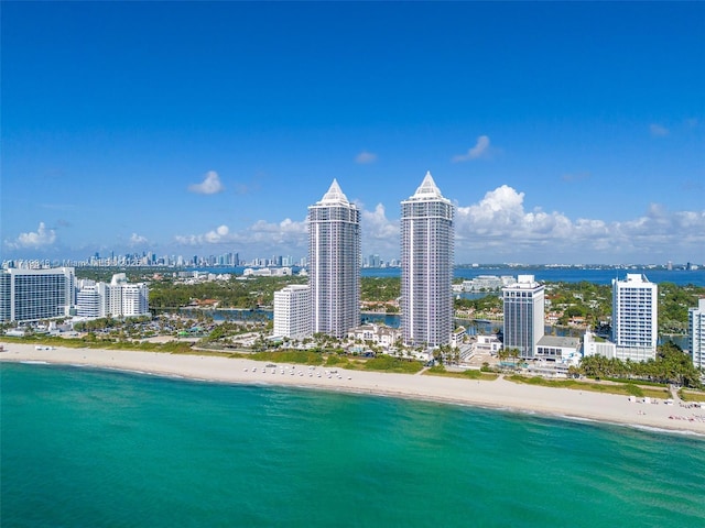 drone / aerial view featuring a beach view and a water view