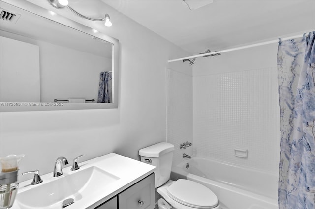 full bathroom with shower / tub combo with curtain, vanity, and toilet