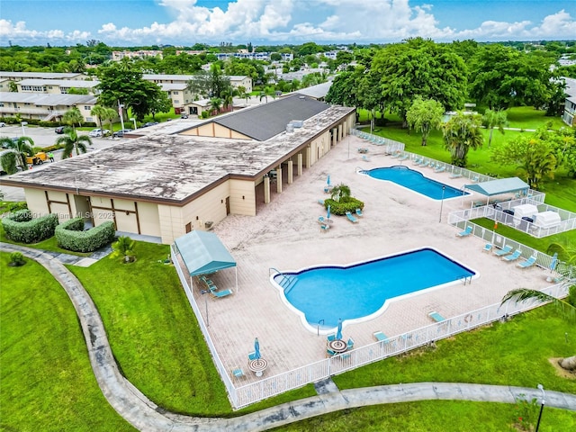 view of pool with a patio and a lawn