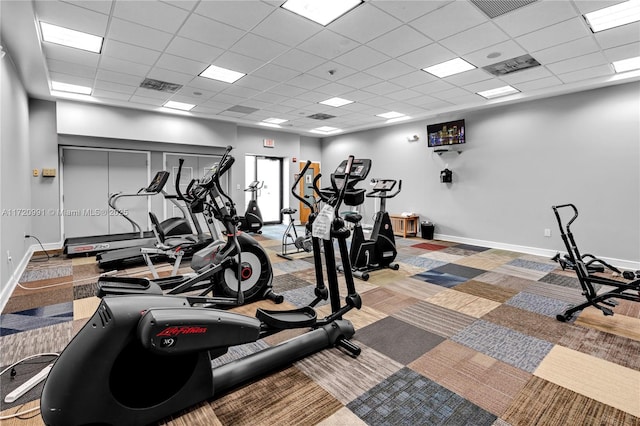 workout area with a paneled ceiling and carpet floors