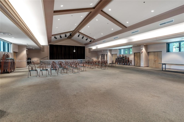 interior space featuring light colored carpet and lofted ceiling