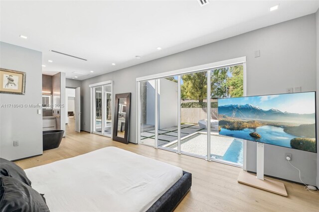 bedroom with light hardwood / wood-style floors and access to exterior