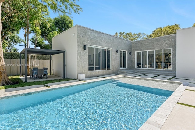 view of pool with an outdoor living space and a patio