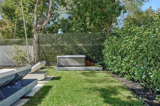 view of yard featuring a jacuzzi and cooling unit