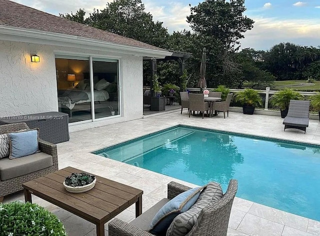 view of pool featuring outdoor lounge area and a patio