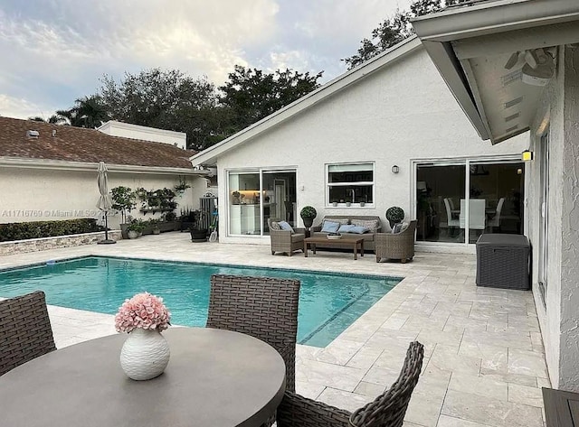 view of pool with outdoor lounge area and a patio area