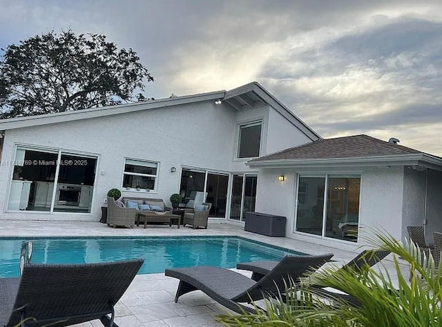 back of house featuring outdoor lounge area and a patio area