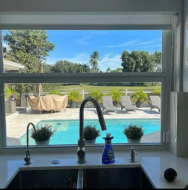 view of swimming pool with sink