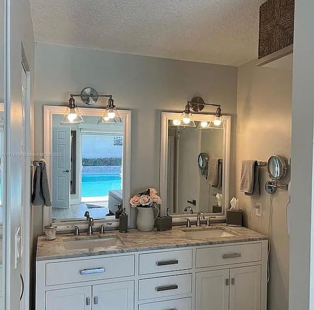 bathroom featuring vanity and a textured ceiling