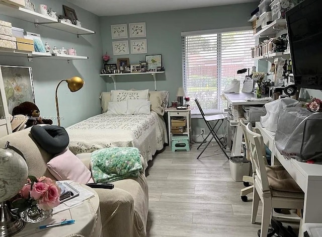 bedroom featuring light wood-type flooring and multiple windows