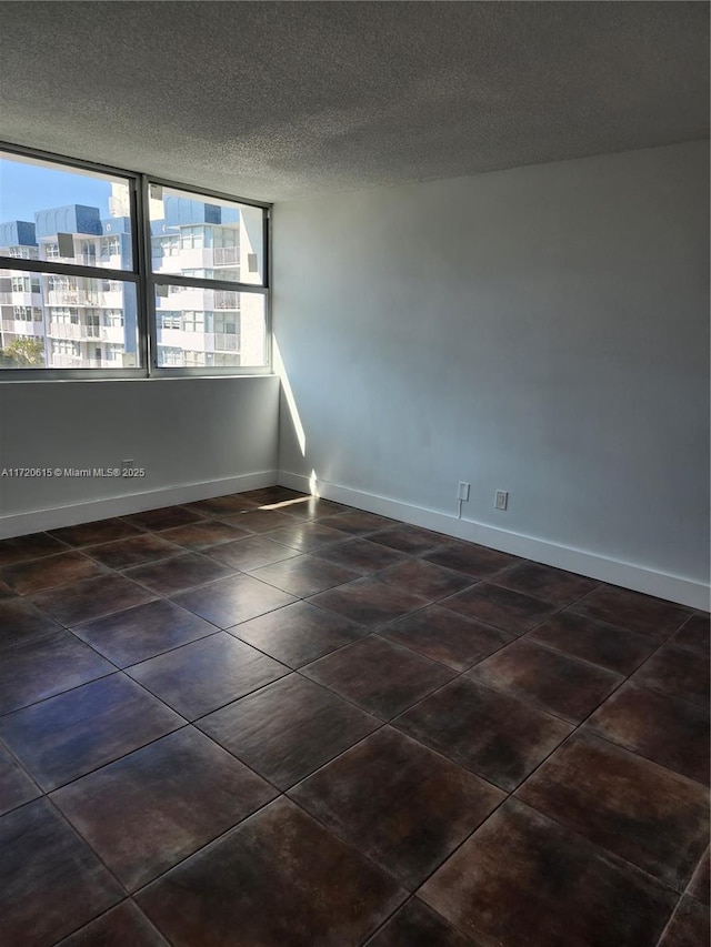 unfurnished room with a textured ceiling