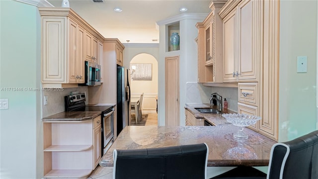 kitchen with kitchen peninsula, appliances with stainless steel finishes, backsplash, crown molding, and sink