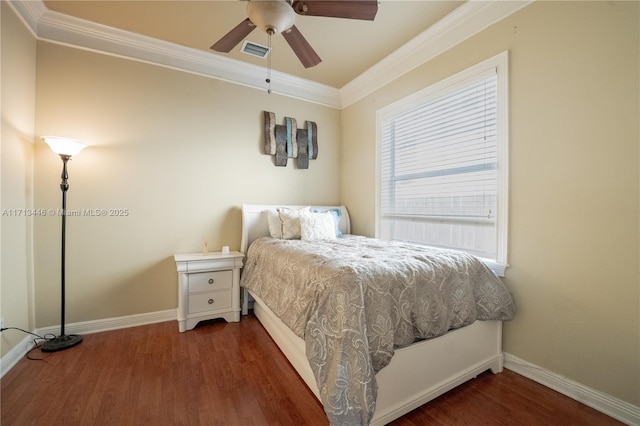 bedroom with ceiling fan, ornamental molding, and dark wood-type flooring