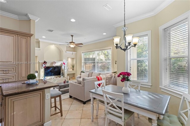 tiled dining room with a notable chandelier and ornamental molding