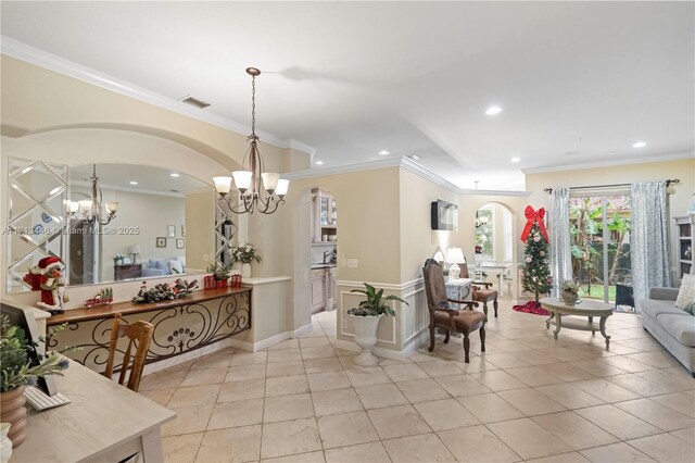 tiled office space featuring ornamental molding and a notable chandelier