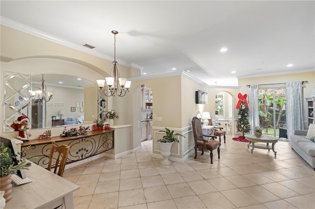 interior space featuring light tile patterned floors, ornamental molding, and a notable chandelier