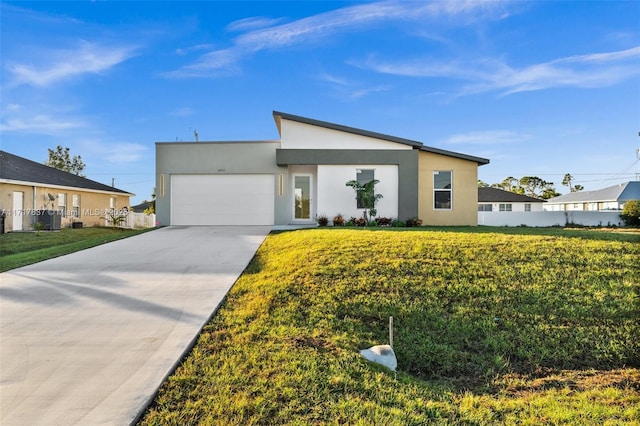 contemporary home with a garage and a front yard