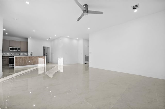 unfurnished living room with ceiling fan and sink