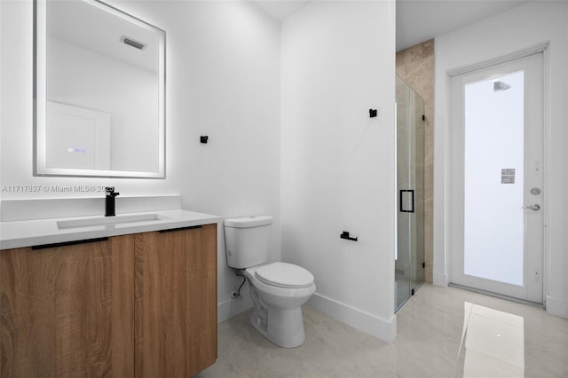 bathroom featuring vanity, toilet, and an enclosed shower