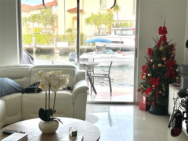 interior space with a water view and tile patterned floors