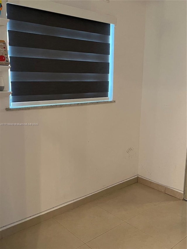 empty room with tile patterned floors