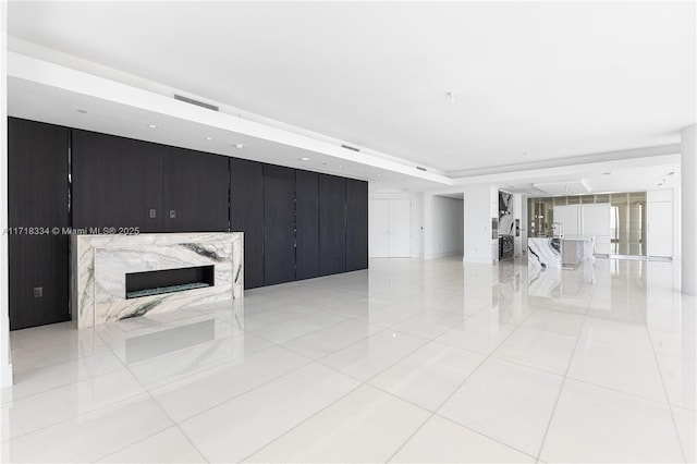 unfurnished living room featuring light tile patterned floors