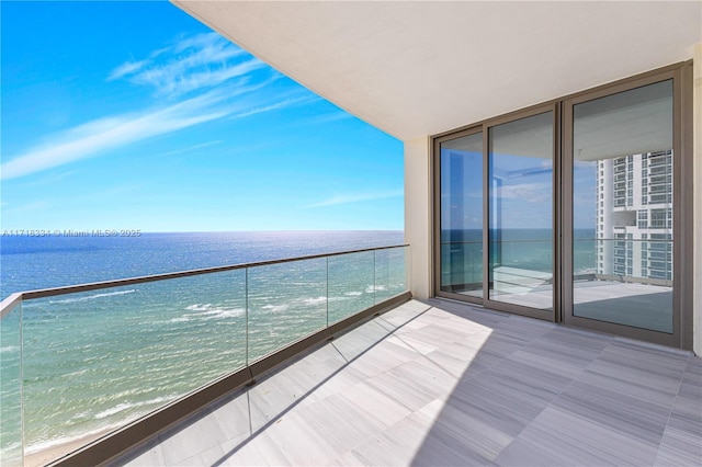 balcony with a water view and a beach view