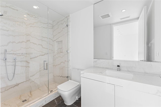 bathroom featuring vanity, toilet, and a shower with door