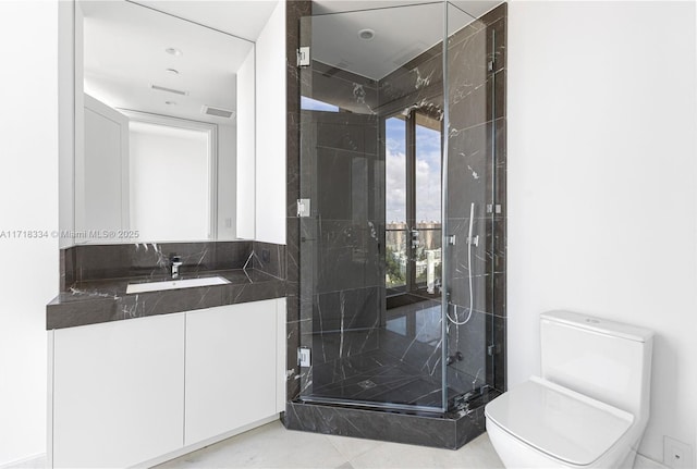 bathroom featuring tile patterned flooring, toilet, an enclosed shower, and vanity