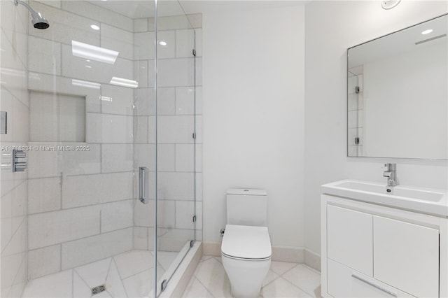 bathroom featuring tile patterned floors, vanity, toilet, and a shower with door