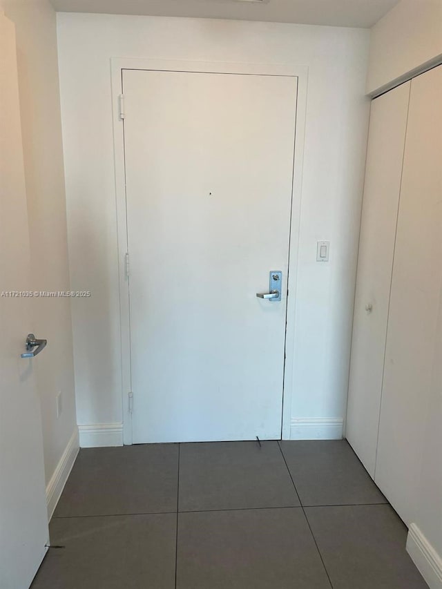 interior space featuring dark tile patterned flooring