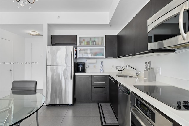 90 SW 3rd St Unit 2603, Miami, FL 33130 - kitchen with stainless steel appliances, a sink, dark cabinetry, tile patterned flooring, and light countertops