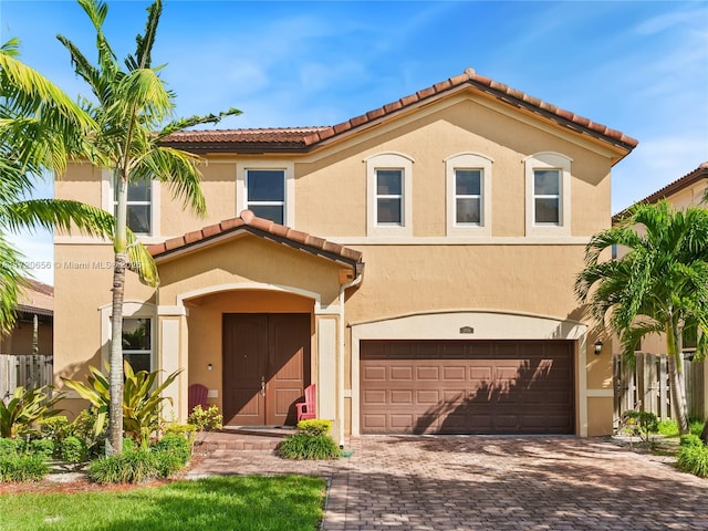 mediterranean / spanish-style house with a garage